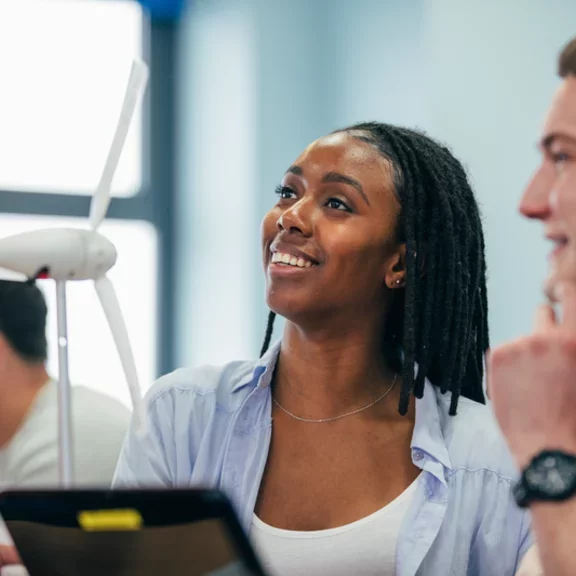 A young woman smiles and enjoys her engineering class